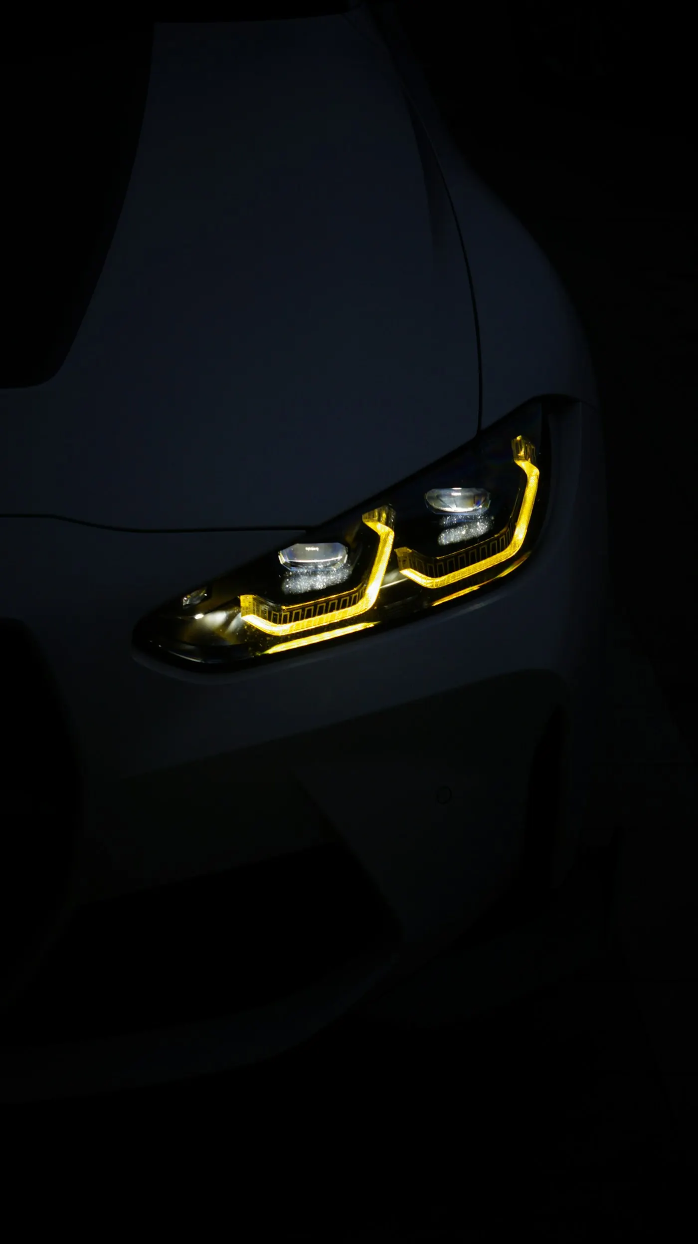 BMW M4 priekinis žibintas su geltonomis dienos šviesomis